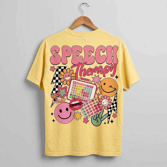 Yellow cotton t-shirt with bold pink "Speech Therapy" text and colorful icons including smiley faces and a speech board, Your Words Matter design.